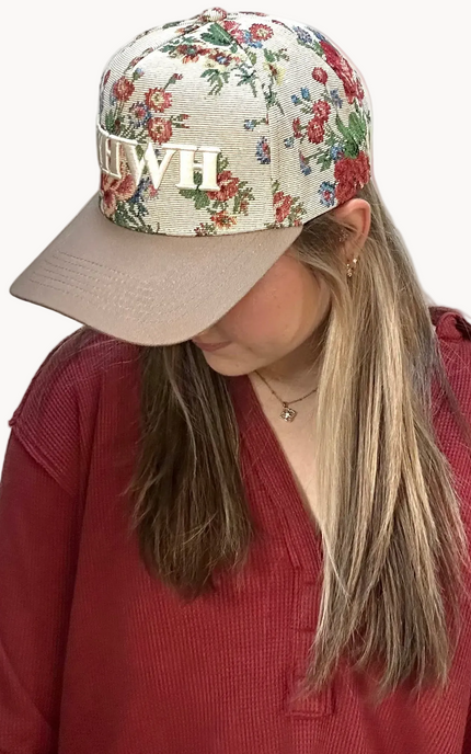 YHWH embroidered floral hat with brown bill and white stitching – adjustable unisex cotton snapback – one-of-a-kind floral pattern – front view on soft linen background – Justyna Grace Boutique