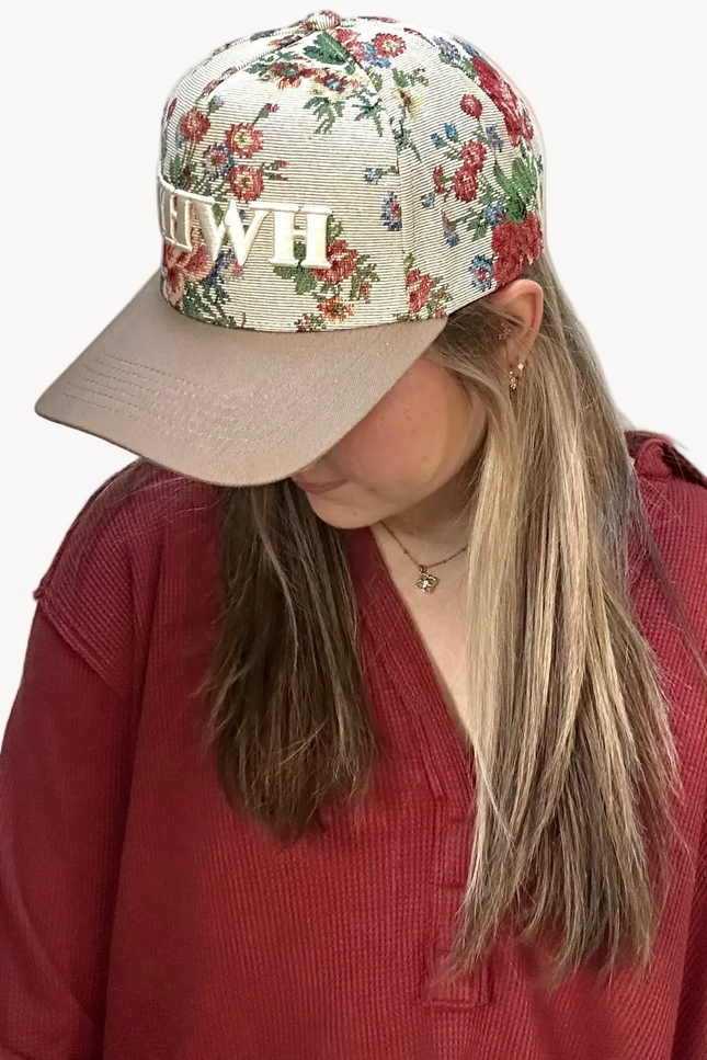 YHWH embroidered floral hat with brown bill and white stitching – adjustable unisex cotton snapback – one-of-a-kind floral pattern – front view on soft linen background – Justyna Grace Boutique