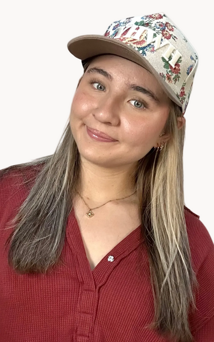 YHWH embroidered floral hat with brown bill and white stitching – adjustable unisex cotton snapback – one-of-a-kind floral pattern – front view on soft linen background – Justyna Grace Boutique