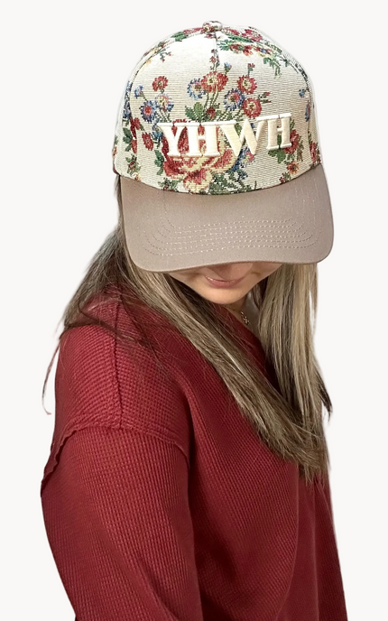 YHWH embroidered floral hat with brown bill and white stitching – adjustable unisex cotton snapback – one-of-a-kind floral pattern – front view on soft linen background – Justyna Grace Boutique