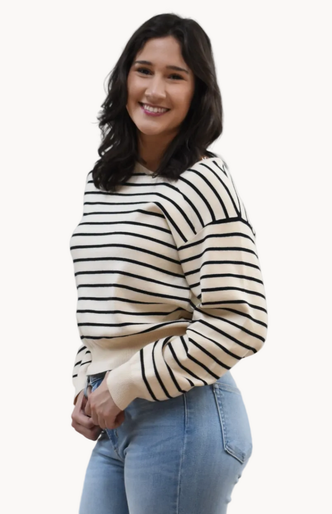 Justyna Top on soft linen background, featuring a soft knit long sleeve and asymmetric boat neckline.