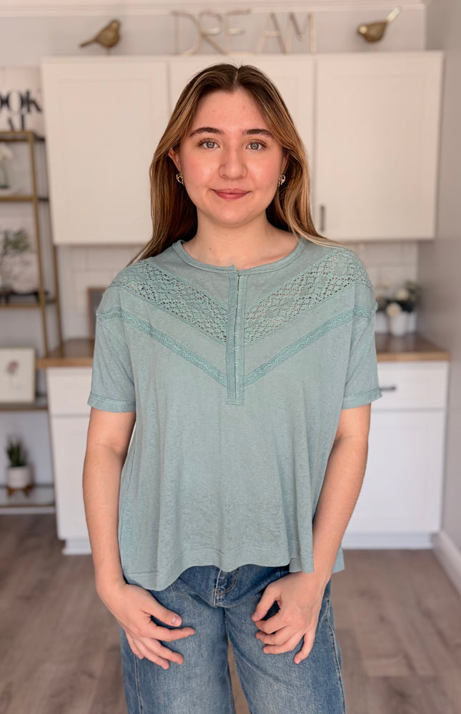 Lightweight relaxed-fit top with cotton lace detail, hook-and-eye front, and drop shoulders