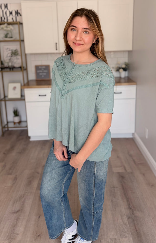 Side view of relaxed-fit top showing drop shoulder and easy, effortless silhouette