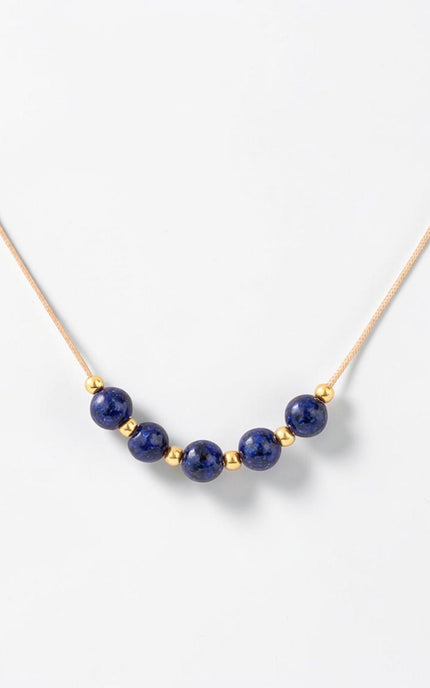 Detailed macro shot of the natural 4.36mm lapis lazuli beads alternating with small gold accents across the center span.