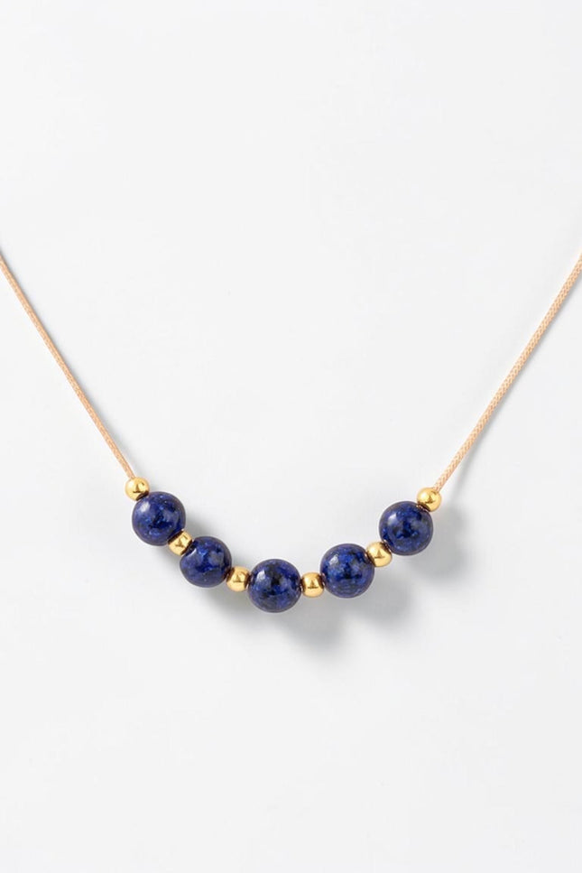 Detailed macro shot of the natural 4.36mm lapis lazuli beads alternating with small gold accents across the center span.