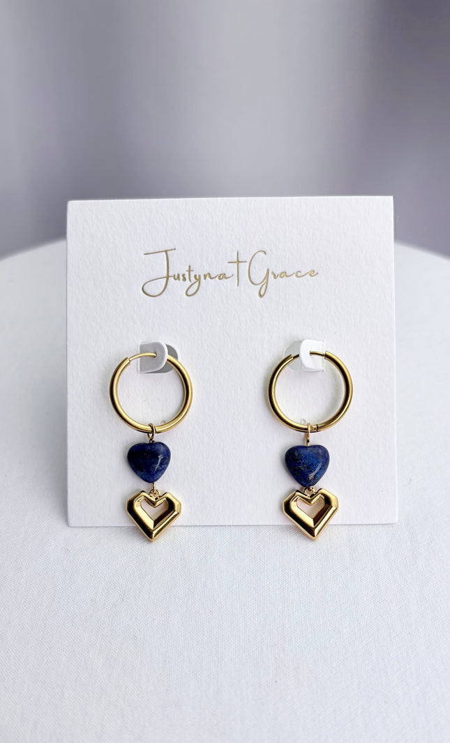 Lapis lazuli and gold heart dangle hoop earrings arranged on a professional display card, showcasing the full 46mm drop design.