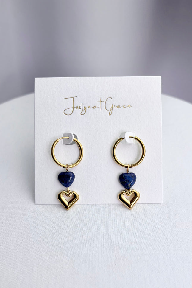 Lapis lazuli and gold heart dangle hoop earrings arranged on a professional display card, showcasing the full 46mm drop design.