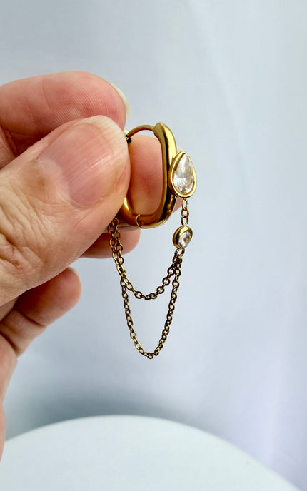 Gold drop hoop earrings with layered chain detail held in hand showing scale, drop length, and 18k gold PVD finish