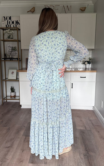 Back view of the Leah floral maxi dress featuring a partially smocked back and adjustable sash