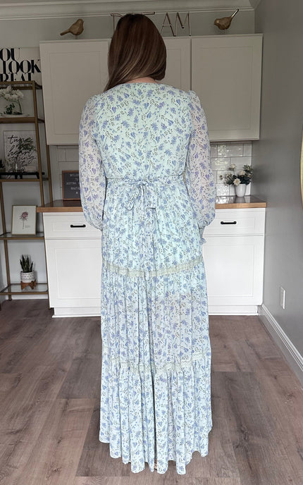 Back view of the Leah floral maxi dress featuring a partially smocked back and adjustable sash
