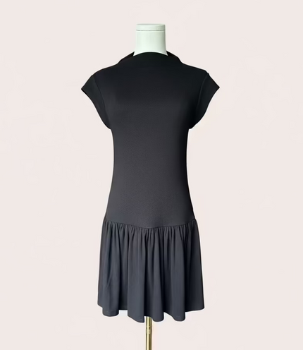 Black knit mini dress with soft drape hem and short sleeves — minimalist modern silhouette from Justyna Grace Boutique.