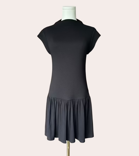 Black knit mini dress with soft drape hem and short sleeves — minimalist modern silhouette from Justyna Grace Boutique.