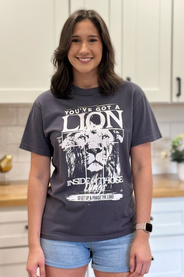 Graphite Comfort Colors tee with “You’ve Got a Lion Inside Those Lungs” worship lyric design, unisex fit and vintage finish.