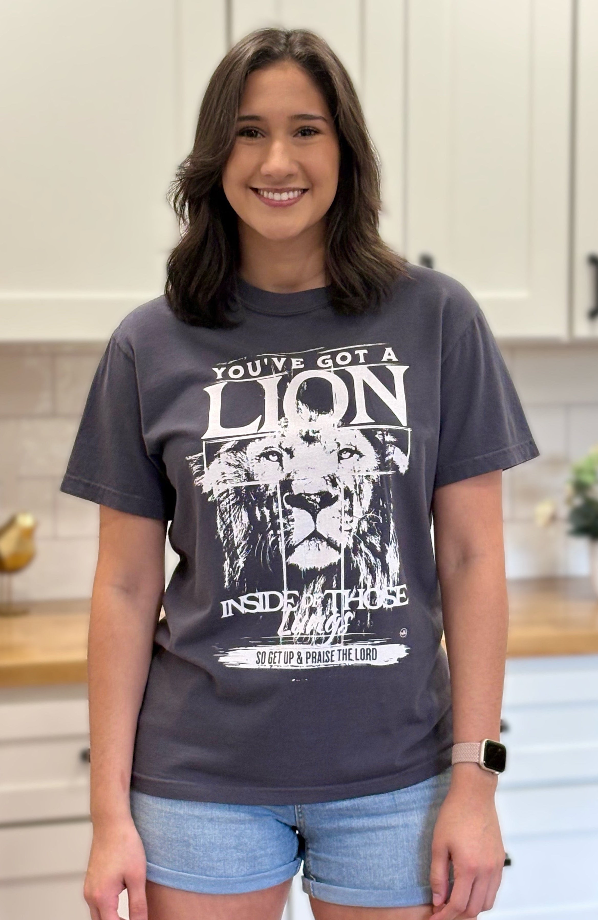 Graphite Comfort Colors tee with “You’ve Got a Lion Inside Those Lungs” worship lyric design, unisex fit and vintage finish.
