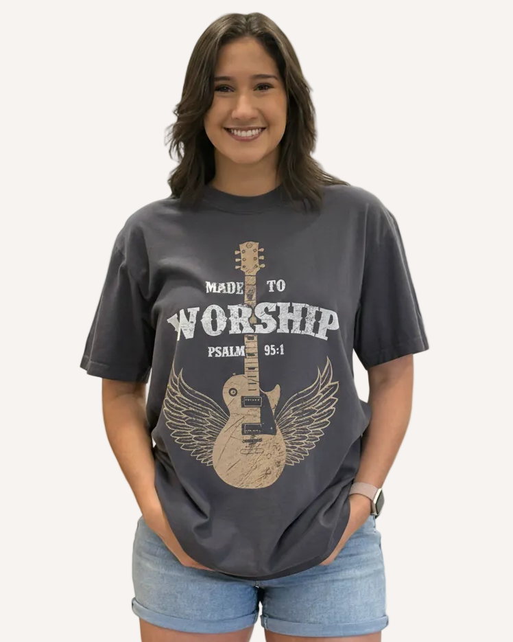 Person wearing a t-shirt with a guitar design and text on a plain background