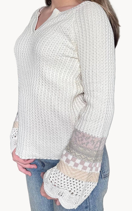 Detail view of the Margot sweater mixed media bell sleeves with scalloped edges