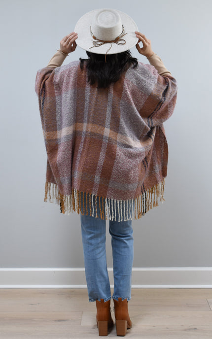 Mauve Meadow Ruana on soft linen background, featuring brushed knit texture and mauve-neutral stripes.
