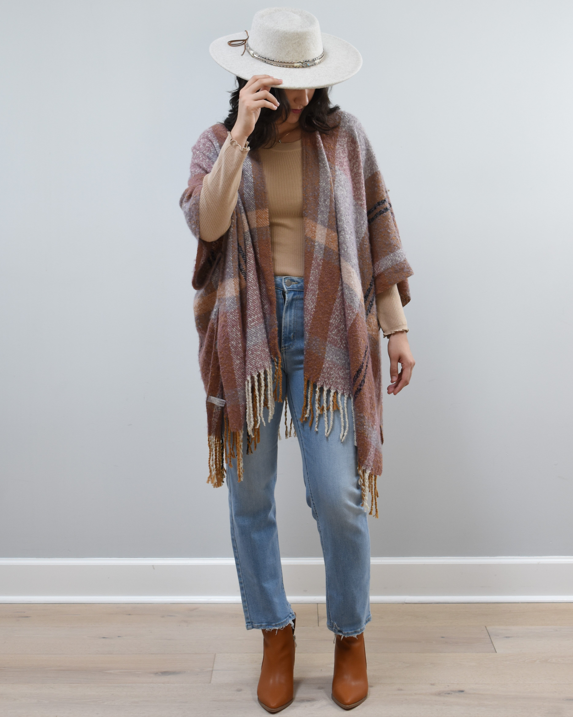 Mauve Meadow Ruana on soft linen background, featuring brushed knit texture and mauve-neutral stripes.