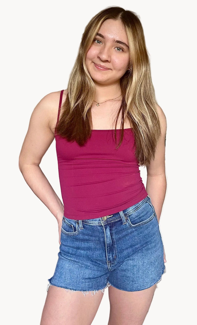 Medium wash high-rise cut-off denim shorts with raw frayed hem