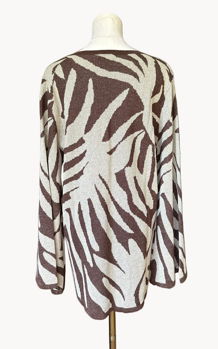 Metallic knit bell-sleeve top with front tie detail and subtle shimmer, relaxed fit and lightweight yarn, photographed on Soft Linen background.