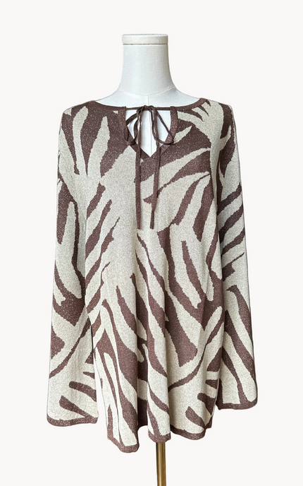 Metallic knit bell-sleeve top with front tie detail and subtle shimmer, relaxed fit and lightweight yarn, photographed on Soft Linen background.
