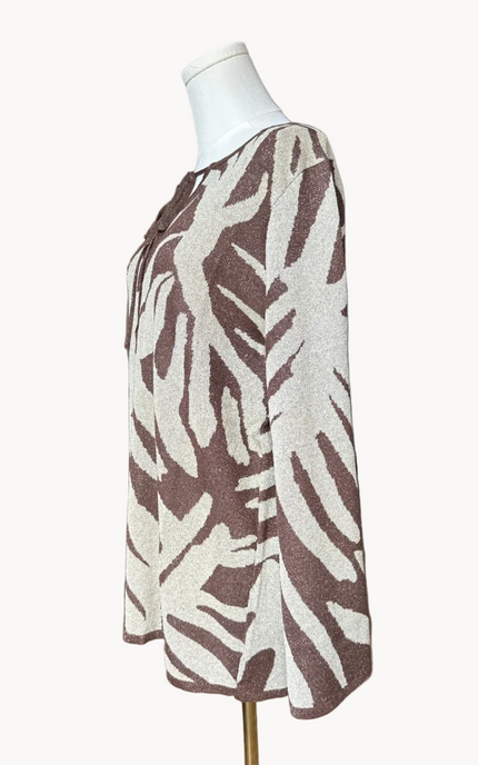 Metallic knit bell-sleeve top with front tie detail and subtle shimmer, relaxed fit and lightweight yarn, photographed on Soft Linen background.