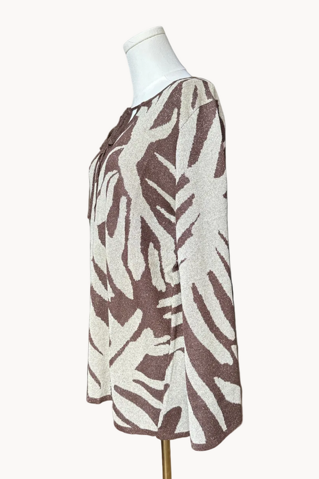 Metallic knit bell-sleeve top with front tie detail and subtle shimmer, relaxed fit and lightweight yarn, photographed on Soft Linen background.
