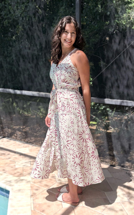 Feminine halter midi dress in abstract floral, designed with surplice front and self-tie belt