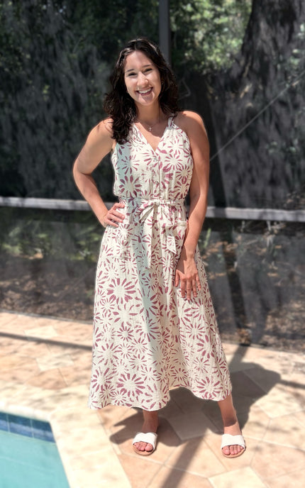 Halter neckline on floral midi dress creating elegant shoulder and neckline frame