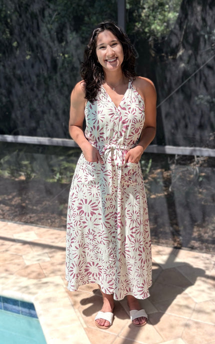 Feminine halter midi dress in abstract floral, designed with surplice front and self-tie belt