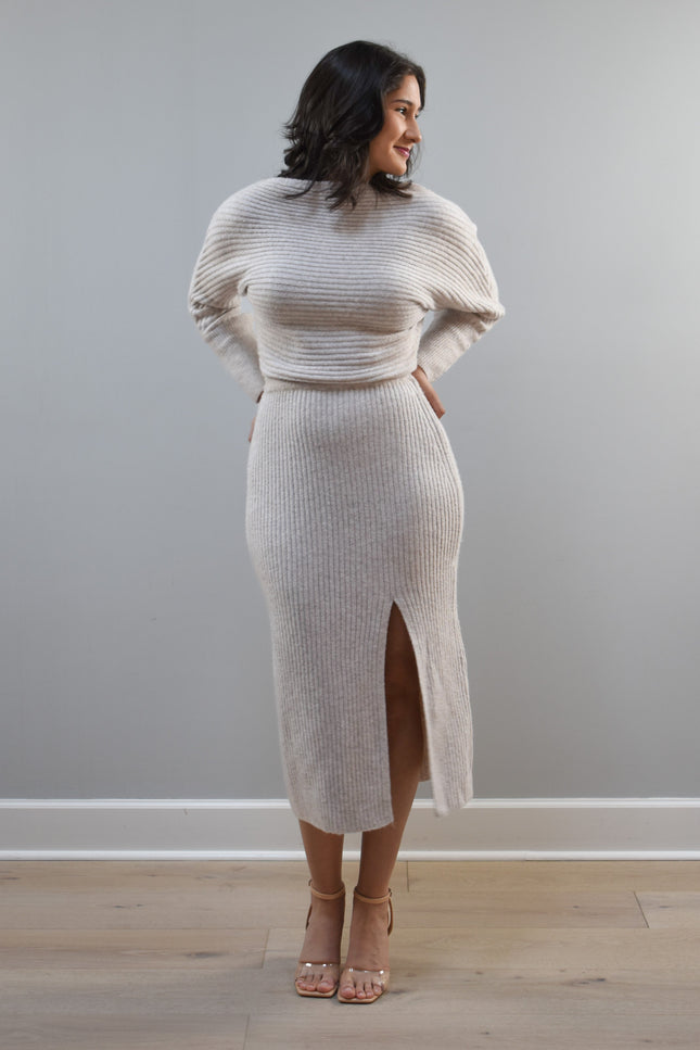 Midi one-shoulder sweater dress on soft linen background, featuring soft stretchy knit and elegant silhouette.