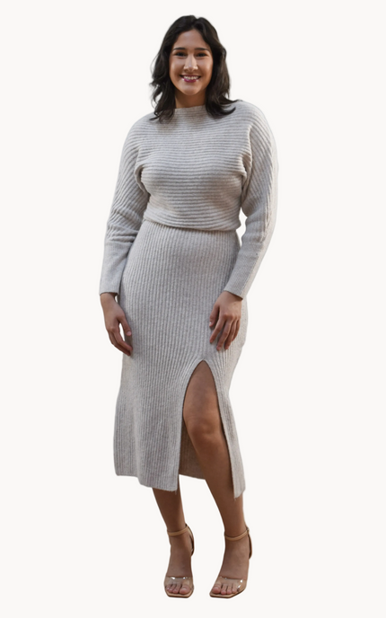 Midi one-shoulder sweater dress on soft linen background, featuring soft stretchy knit and elegant silhouette.