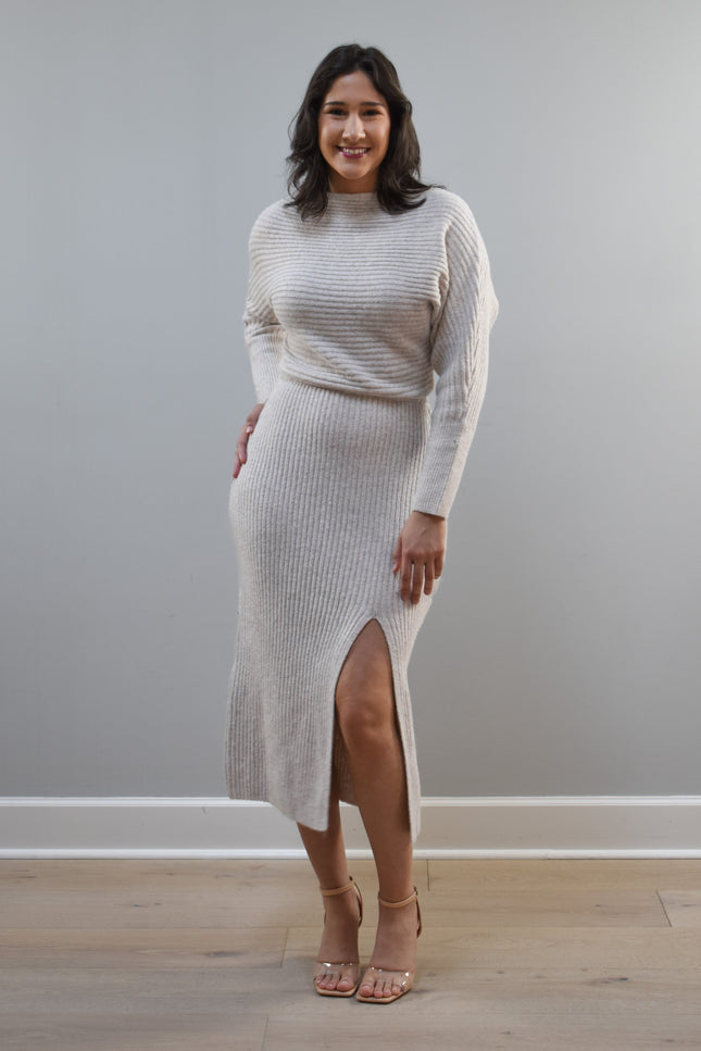 Midi one-shoulder sweater dress on soft linen background, featuring soft stretchy knit and elegant silhouette.