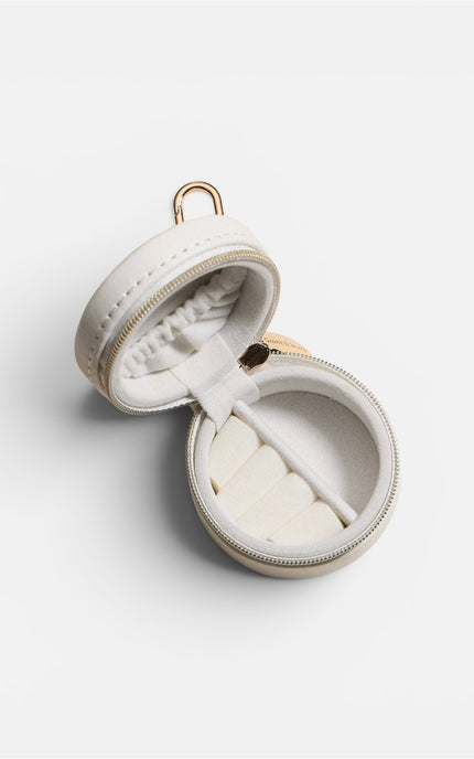An open view of the mini jewelry case, showcasing the plush velvet lining with dedicated slots designed to hold rings and earrings securely.