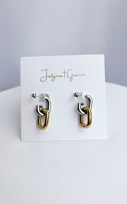 Mixed metal gold and silver link earrings displayed on jewelry card showing clean modern design and polished finish