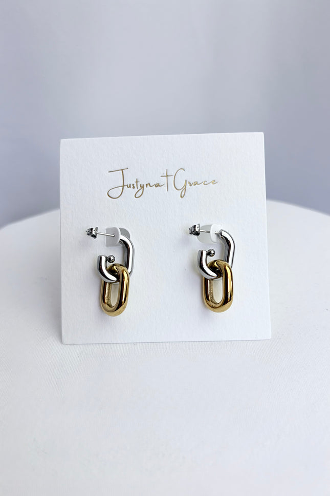 Mixed metal gold and silver link earrings displayed on jewelry card showing clean modern design and polished finish