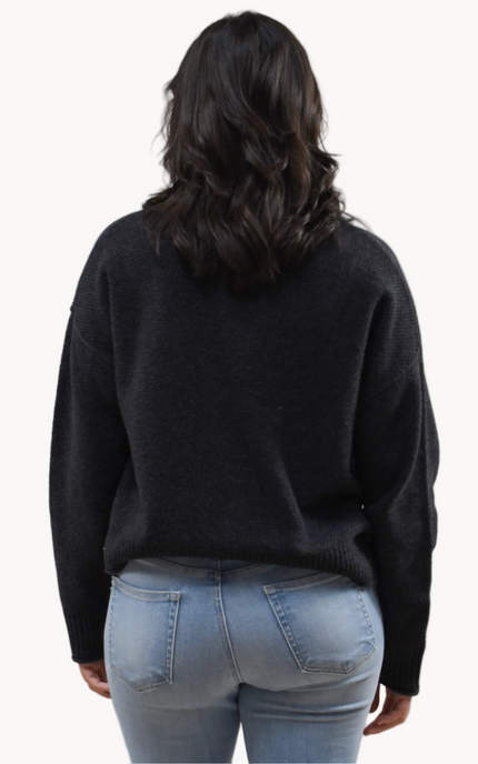 Neutral mock neck long-sleeve sweater top on soft linen background, made from a cozy knit blend.