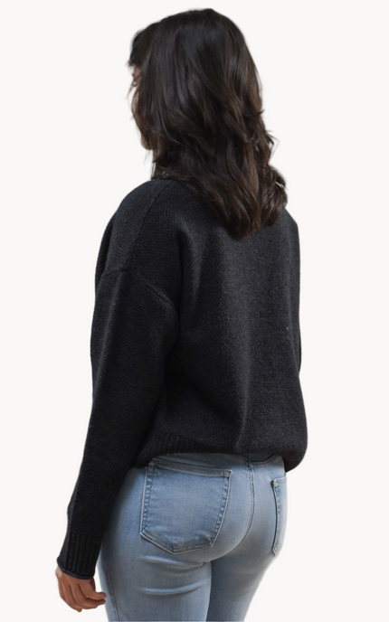 Neutral mock neck long-sleeve sweater top on soft linen background, made from a cozy knit blend.