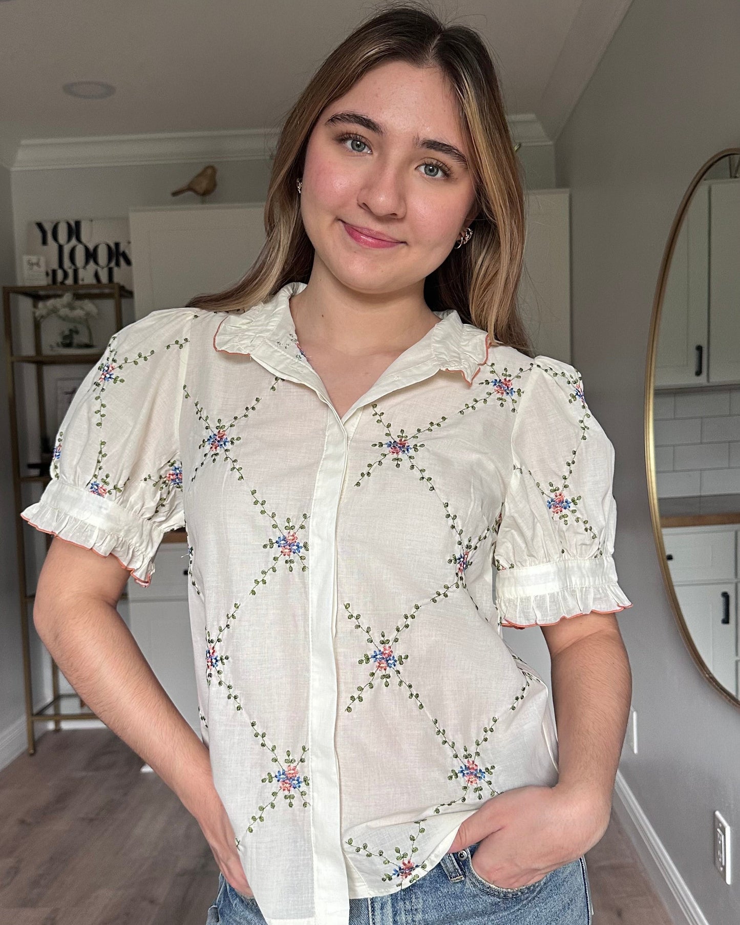 Front view of Noemi blouse ruffle collar with contrast edging and floral embroidered detail