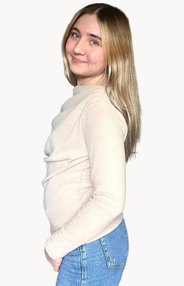 Side view of off shoulder knit top highlighting asymmetrical neckline and soft knit fabric