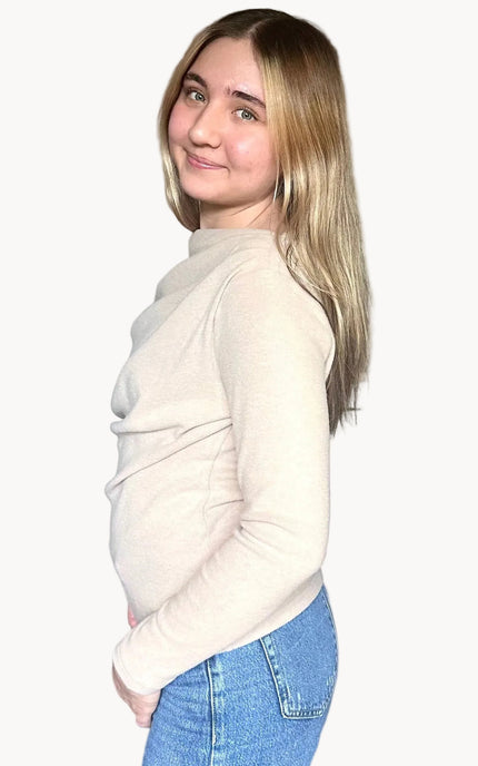Side view of off shoulder knit top highlighting asymmetrical neckline and soft knit fabric