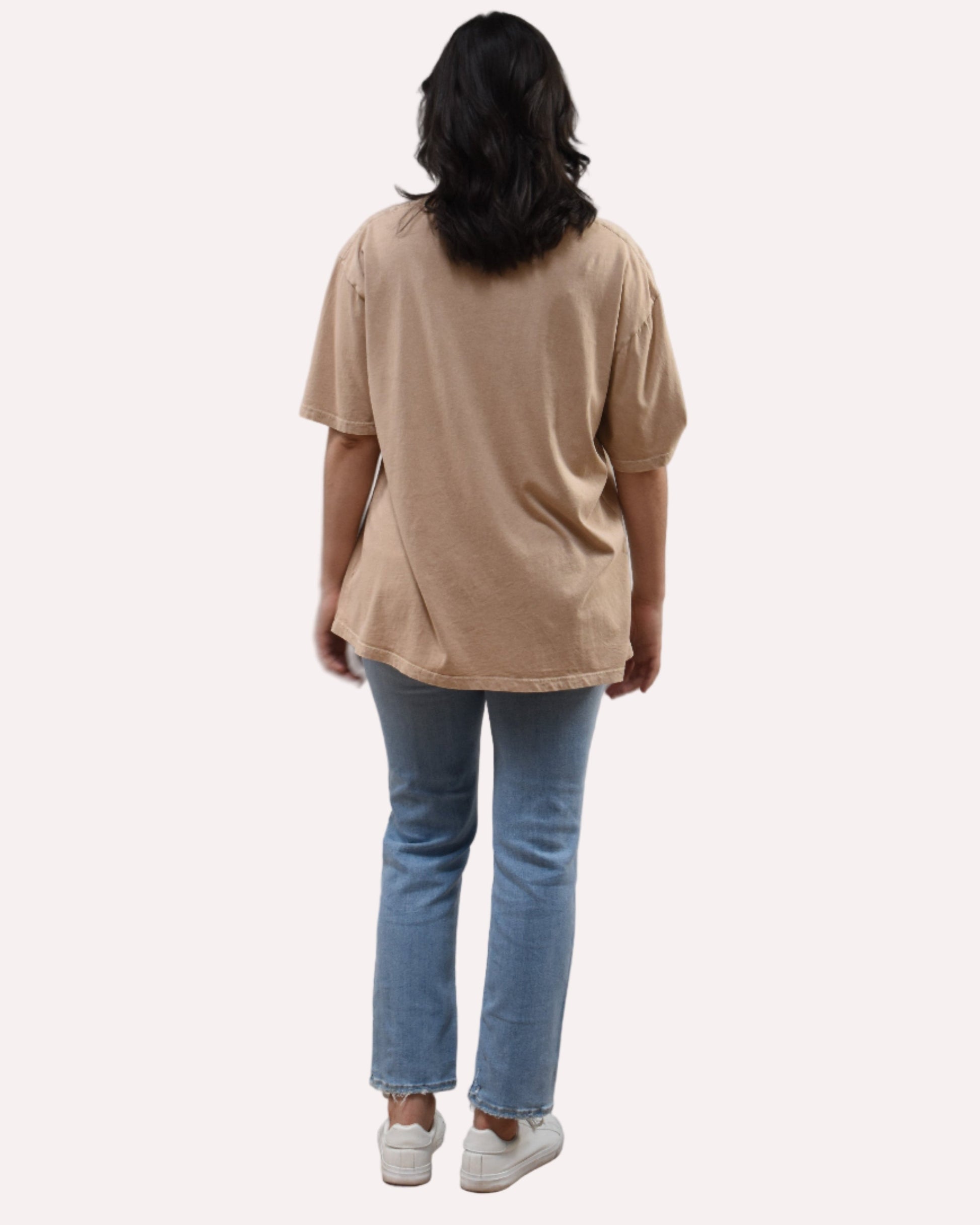 Oversized vintage graphic tee on soft linen background, featuring garment-dyed cotton and mineral-wash texture.