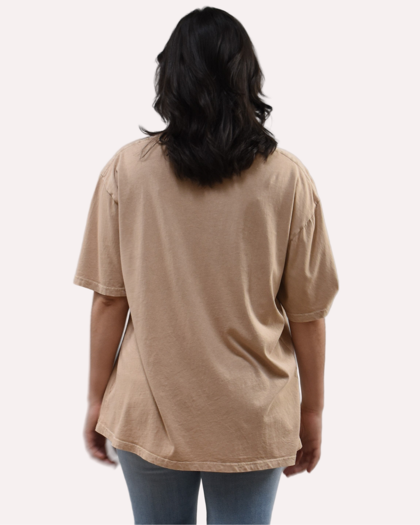 Oversized vintage graphic tee on soft linen background, featuring garment-dyed cotton and mineral-wash texture.