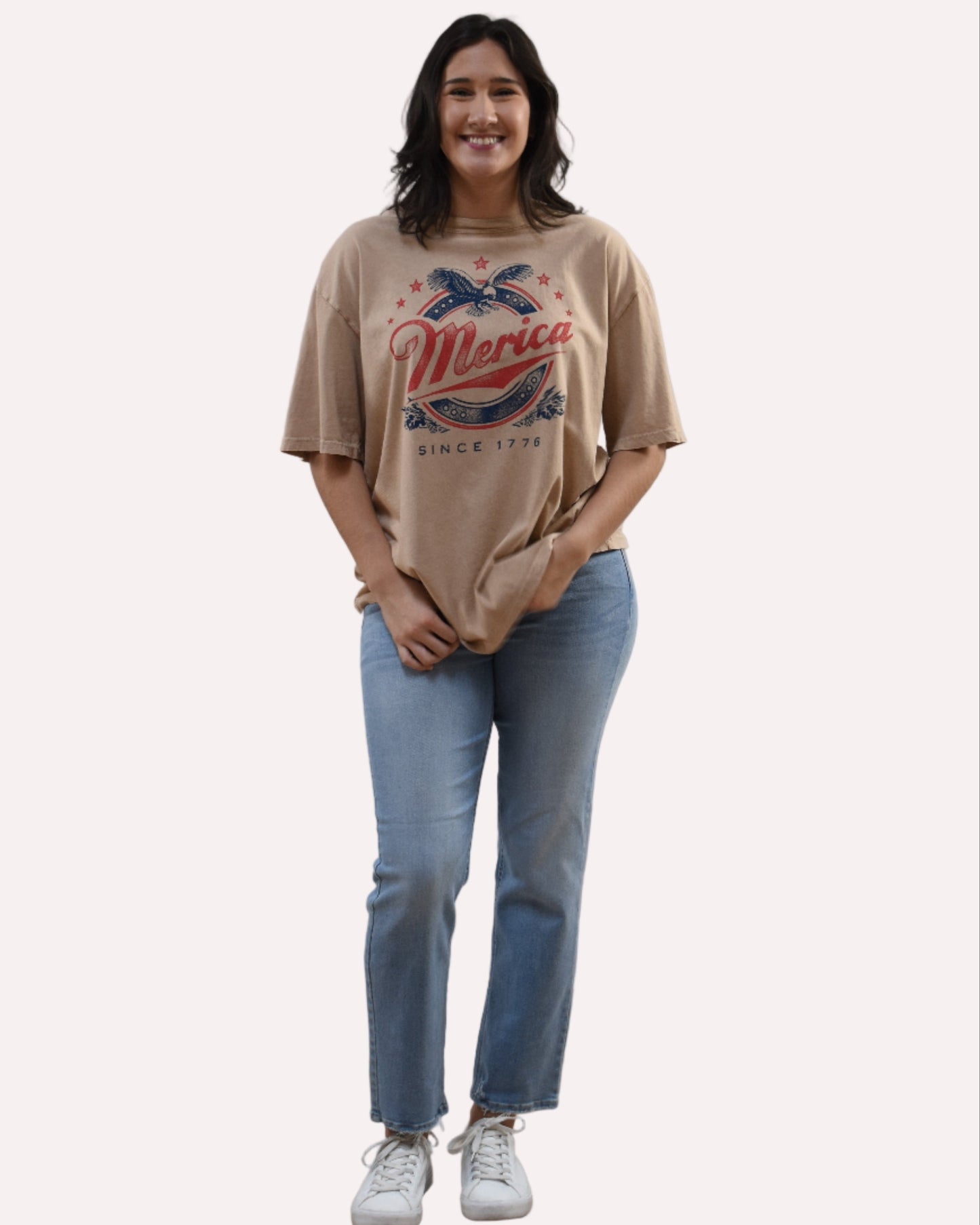 Oversized vintage graphic tee on soft linen background, featuring garment-dyed cotton and mineral-wash texture.