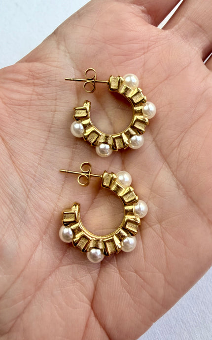 Elegant pearl‑kissed hoops designed to elevate any outfit. Made with premium stainless steel and 18k gold PVD for shine that lasts.
