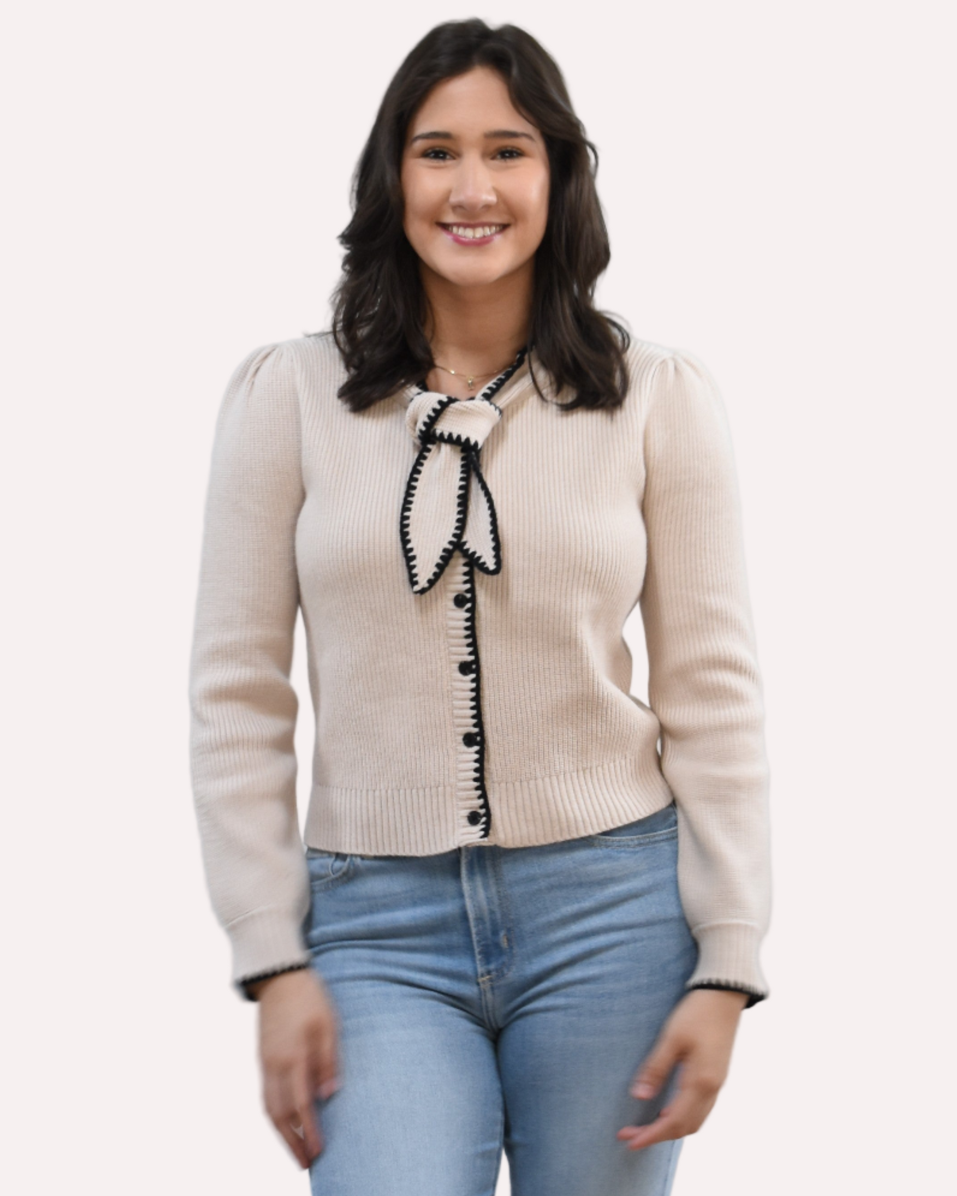 Petite Bow Knit Cardi on soft linen background, featuring a contrast-knit body and delicate bow detail at the neckline.