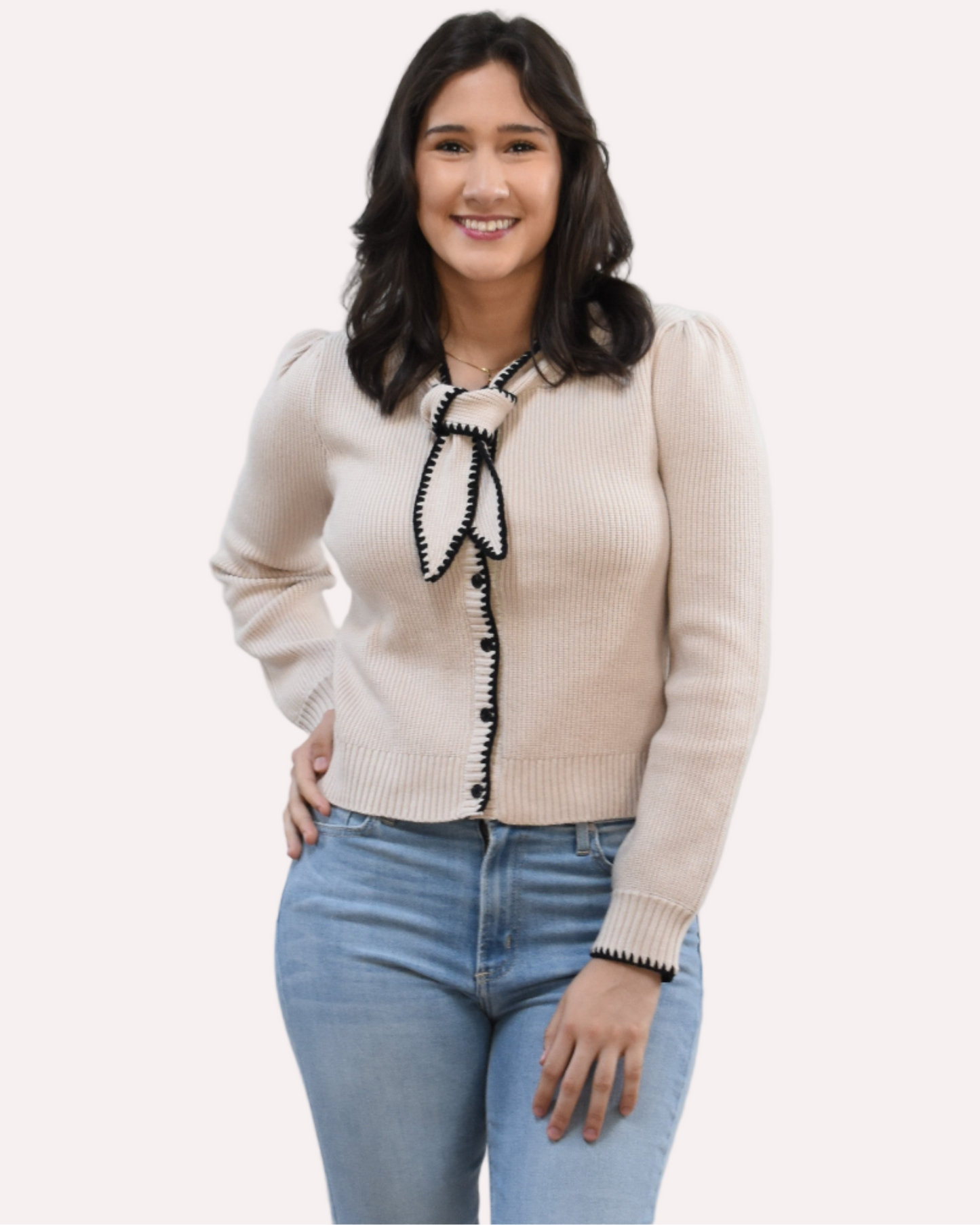 Petite Bow Knit Cardi on soft linen background, featuring a contrast-knit body and delicate bow detail at the neckline.