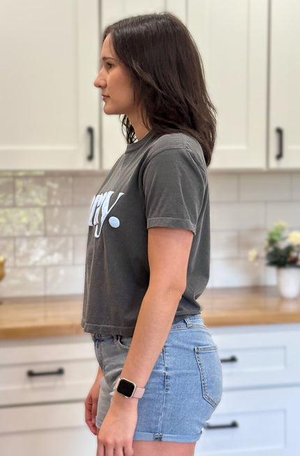 Charcoal gray cropped tee with bold ‘pray.’ text — modern faith graphic tee from Justyna Grace Boutique.