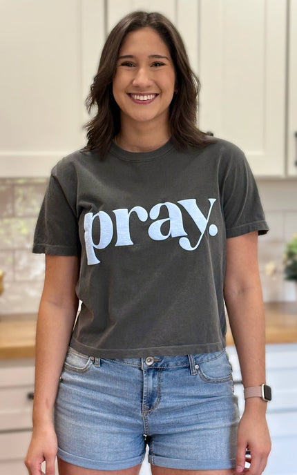 Charcoal gray cropped tee with bold ‘pray.’ text — modern faith graphic tee from Justyna Grace Boutique.