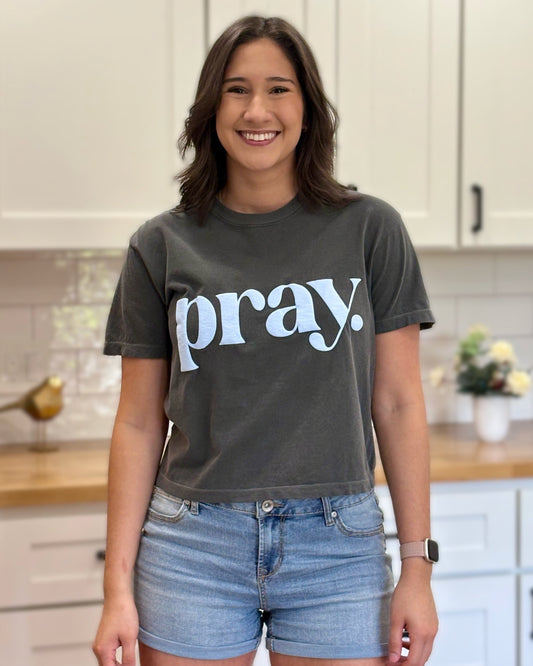 Charcoal gray cropped tee with bold ‘pray.’ text — modern faith graphic tee from Justyna Grace Boutique.